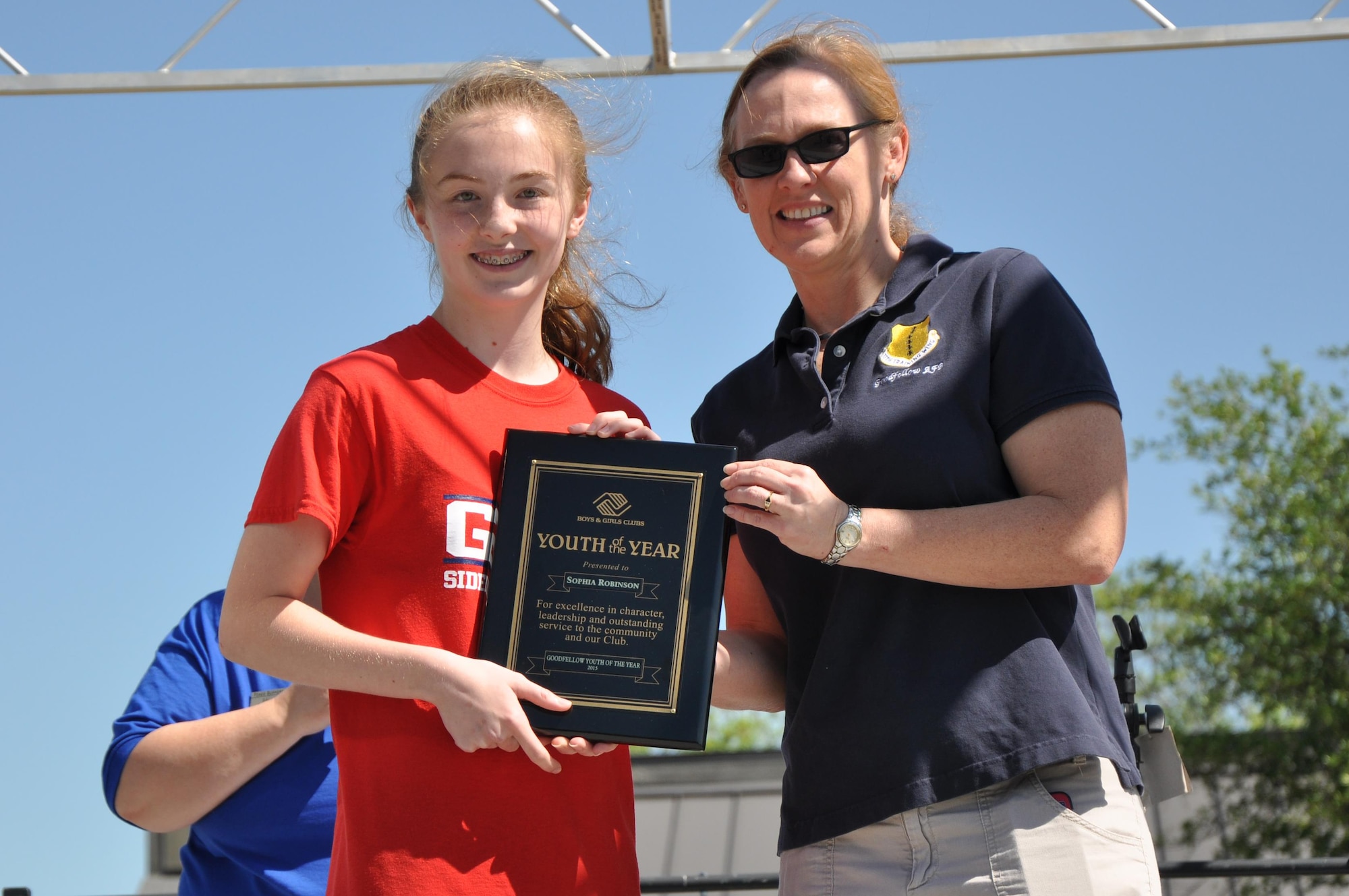GOODFELLOW AIR FORCE BASE, Texas – Col. Kimberlee P. Joos, 17th Training Wing Commander, presents Sophia Robinson, Goodfellow youth, with the 2015 Goodfellow Youth of the Year award during the Month of the Military Child "What's Your Story" Children's Fair at the youth complex April 25. Sophia is competing at the state level against other Defense Department children for Texas Youth of the Military. (U.S. Air Force photo/ Senior Airman Joshua Edwards)