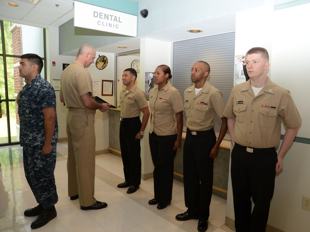 Lt. Cmdr. Raymond Bristol, officer-in-charge, Naval Branch Health Clinic Albany located at Marine Corps Logistics Base Albany, presents promotion commendations to sailors in a frocking ceremony, here, May 28. Sailors frocked for promotion were (left to right): HM2 Ricky Cuevas; HM3 Cholee Ward; HN Aundrea Maddox and HN Roderick Frederick. HM3 Nicholas Gilchrist and HN Benjamin Rozeboom, who are also promotion recipients, are scheduled to be frocked in a separate ceremony.