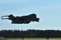 A C-17 Globemaster from Charleston Air Force Base, S.C. takes off, May 27, 2015, from Hurlburt Field, Fla. The C-17, loaded with 823rd RED HORSE members and medical vehicles, took off in support of NEW HORIZONS 2015, an annual event conducted to train military civil engineers and medical professionals to deploy and conduct joint operations. (U.S. Air Force photo by Airman 1st Class Ryan Conroy/Released)  

