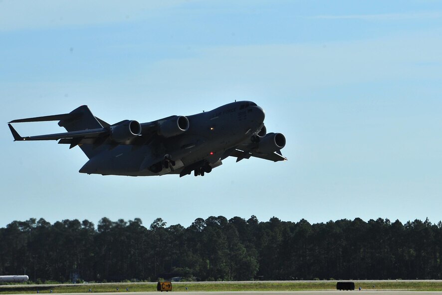 A C-17 Globemaster from Charleston Air Force Base, S.C. takes off, May 27, 2015, from Hurlburt Field, Fla. The C-17, loaded with 823rd RED HORSE members and medical vehicles, took off in support of NEW HORIZONS 2015, an annual event conducted to train military civil engineers and medical professionals to deploy and conduct joint operations. (U.S. Air Force photo by Airman 1st Class Ryan Conroy/Released)  

