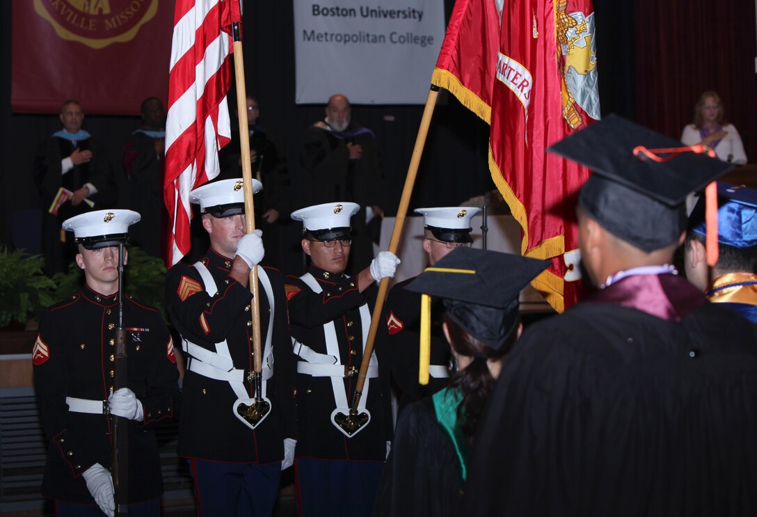 Graduates and guests of honor stand for the national anthem during the 40th annual graduation recognition ceremony at Marine Corps Air Station Cherry Point, North Carolina, May 28, 2015. The Ceremony was held to honor students’ extraordinary accomplishments as they completed degrees in their fields of study.