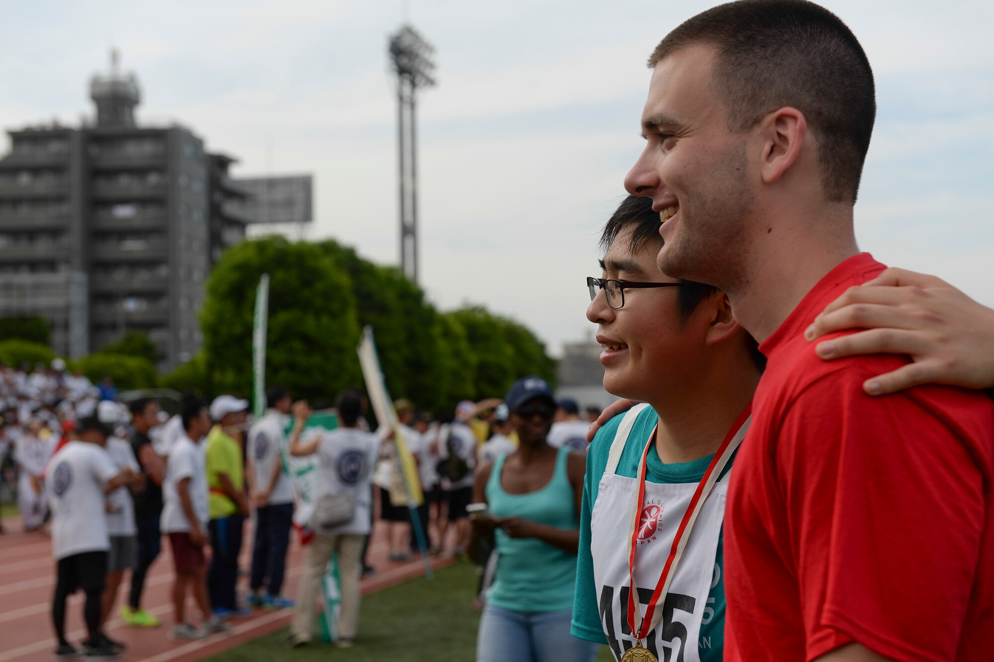 Hirokaza Nakano, left, an athlete in the 36th Annual Kanto Plains Special Olympics, poses with his “buddy,” Senior Airman Patrick Cole, 374th Airlift Wing broadcaster at Yokota Air Base, Japan, May 30, 2015. Each athlete was assigned a buddy, or a volunteer to escort, keep company with, and cheer on their athlete throughout the event. (U.S. Air Force photo by Airman 1st Class Elizabeth Baker/Released)