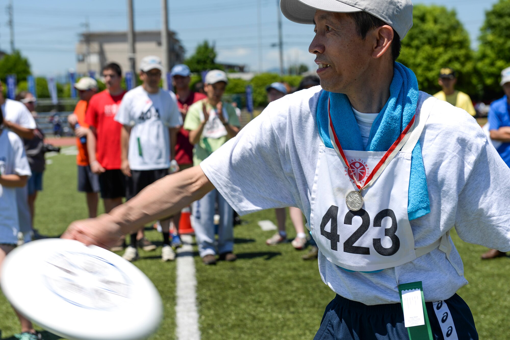 An athlete in the Kanto Plains Special Olympics participates in the frisbee throwing event at Yokota Air Base, Japan, May 30, 2015. Athletes were given the opportunity to participate in a variety of sports including softball, soccer, and track. (U.S. Air Force photo by Airman 1st Class Elizabeth Baker/Released)