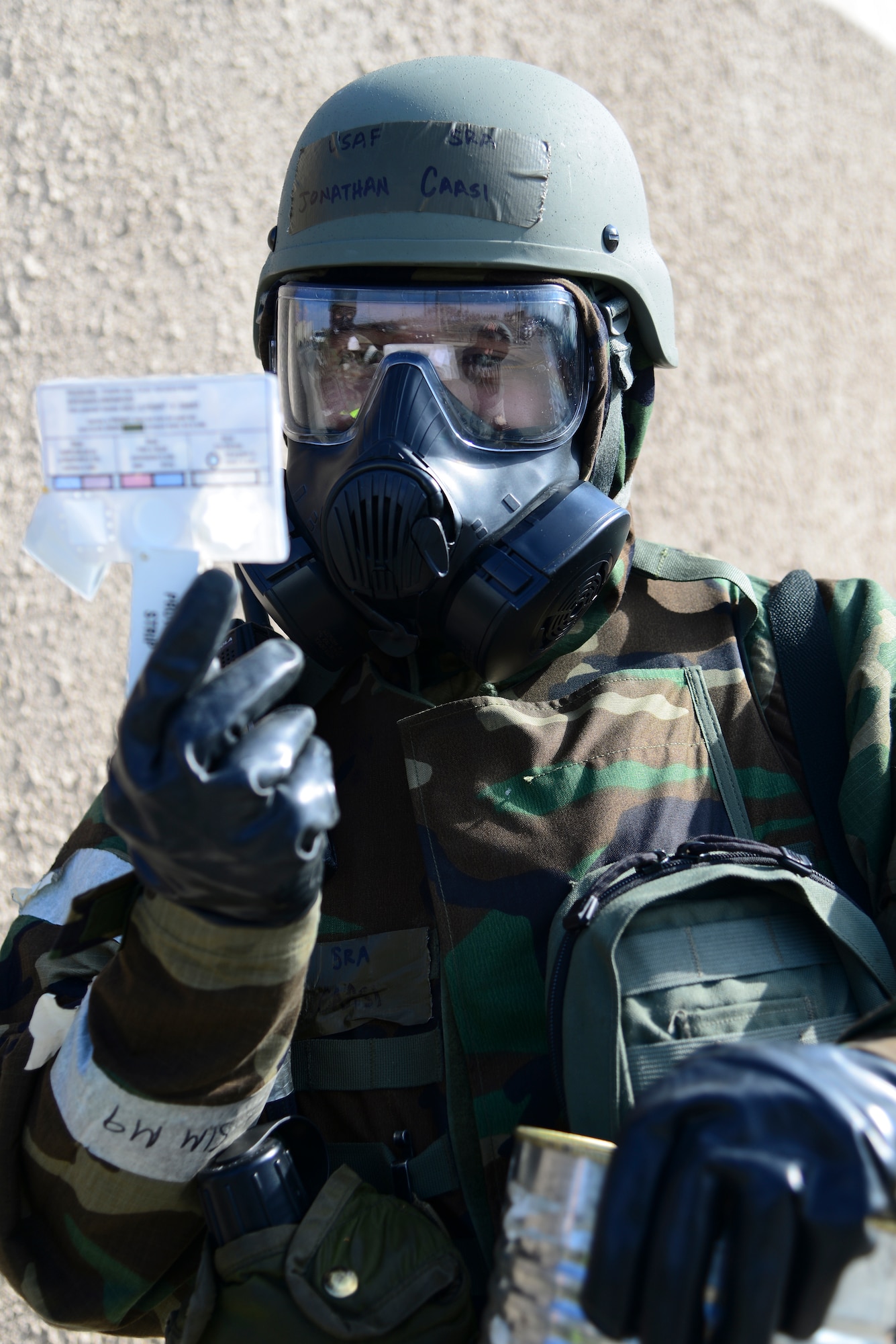 Senior Airman Jonathan Caasi, 51st Civil Engineer Squadron emergency manager, checks the sample for contamination during Operational Readiness Exercise Beverly Midnight 15-1 March 4, 2015, at Osan Air Base, Republic of Korea. If the M8 chemical detection paper be comes contaminated, addition tests will be done to determine if the air has nerve, blood or blister agents. (U.S. Air Force photo by Senior Airman Matthew Lancaster)
