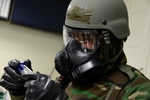 Senior Airman Jonathan Caasi, 51st Civil Engineer Squadron emergency manager, exams an air sample during Operational Readiness Exercise Beverly Midnight 15-1 March 4, 2015, at Osan Air Base, Republic of Korea. The sample is tested to determine if the air is containmined with biological agents. (U.S. Air Force photo by Senior Airman Matthew Lancaster)