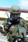 Senior Airman Jonathan Caasi, 51st Civil Engineer Squadron emergency manager, radio in his findings during Operational Readiness Exercise Beverly Midnight 15-1 March 4, 2015, at Osan Air Base, Republic of Korea. After checking the M8 chemical detection paper, Caasi must report whether it has containmination or not. (U.S. Air Force photo by Senior Airman Matthew Lancaster)