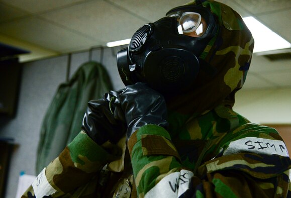 Staff Sgt. Steven Staab, 51st Aerospace Medicine Squadron NCO in charge of radiation, dons his mission oriented protective posture during Operational Readiness Exercise Beverly Midnight 15-1 March 4, 2015, at Osan Air Base, Republic of Korea. When chemical, biological, radiological or nuclear agents are suspected in the air everyone must put on all of their MOPP gear. (U.S. Air Force photo by Senior Airman Matthew Lancaster)