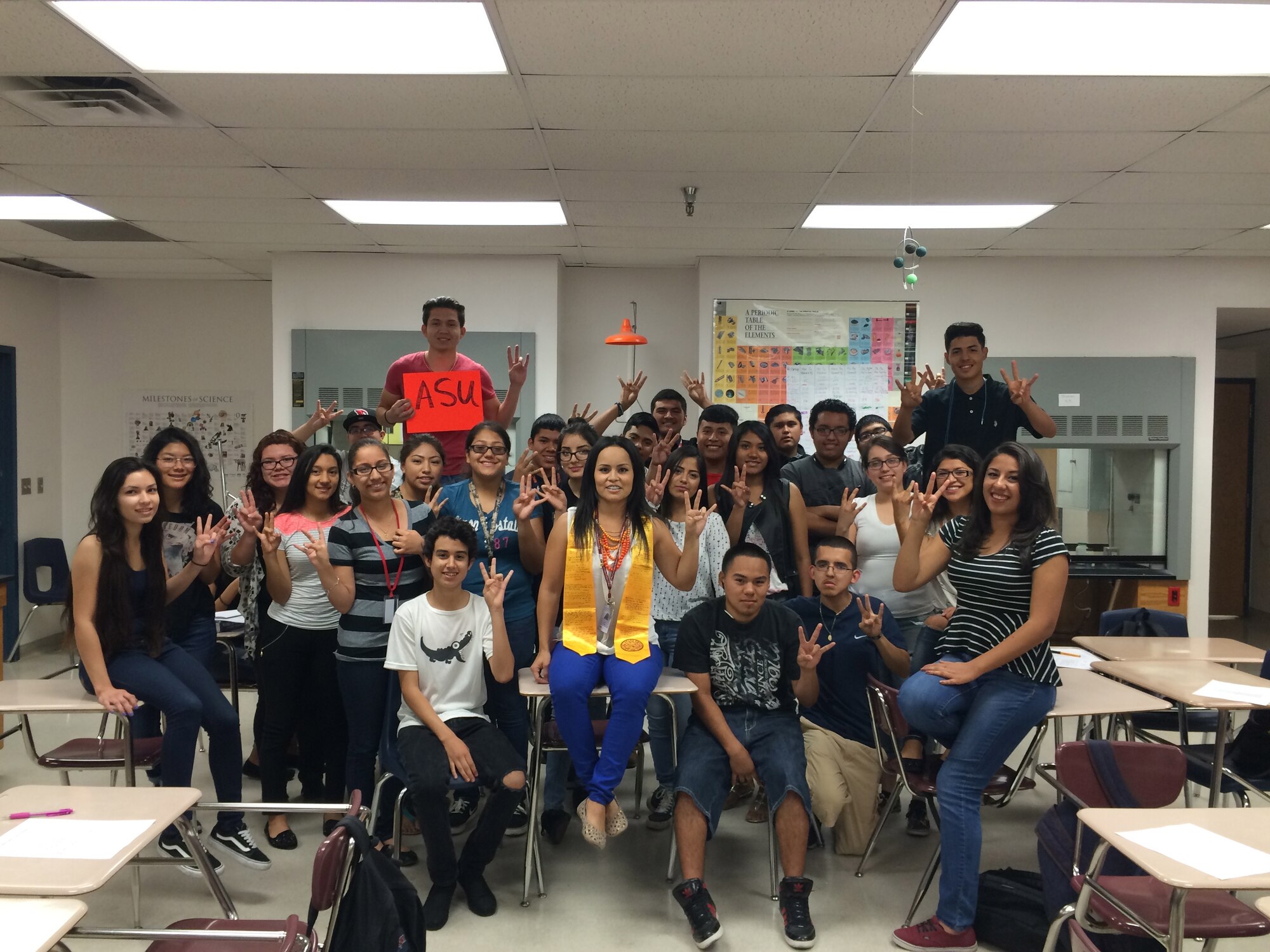 SSgt Perla Tapia Cordero, 69th Fighter Squadron personnel journeyman, poses with her students after graduating from Arizona State University. It took nine years to earn her degree but she fought through all the obstacles. (Courtesy Photo) 