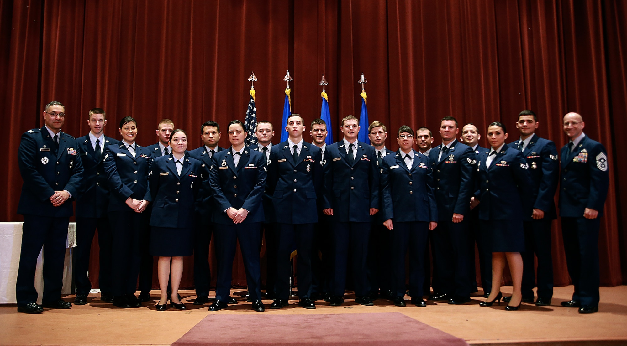 Mighty Ninety enlisted Airmen who promoted in May pose in the F.E. Warren Base Theater June 1, 2015, with Col. Stephen Kravitsky, 90th Missile Wing commander, and Chief Master Sgt. Samuel Couch, 90th Missile Wing command chief. Each month, the Mighty Ninety gathers to honor those who have earned the next rank. (Courtesy photo)