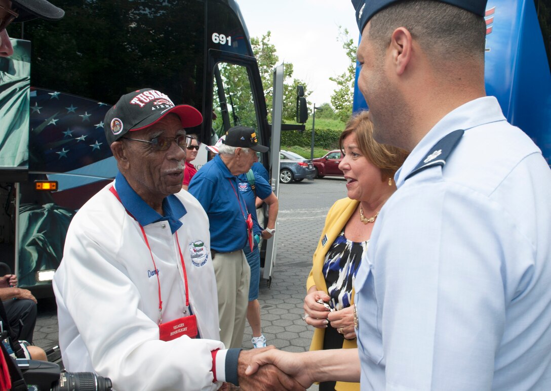 Daniel Keel, a Tuskegee Airman flight officer, navigator, bombardier and B-24 pilot, is greeted by Lt. Col. Malcolm Pharr, the secretary of the Air Force International Affairs Key Leader Engagements chief, at the Air Force Memorial in Washington, D.C., May 27, 2015. Keel attended the memorial with 34 honor flight participants from North Central Florida. (U.S. Air Force Photo/Staff Sgt. Carlin Leslie)