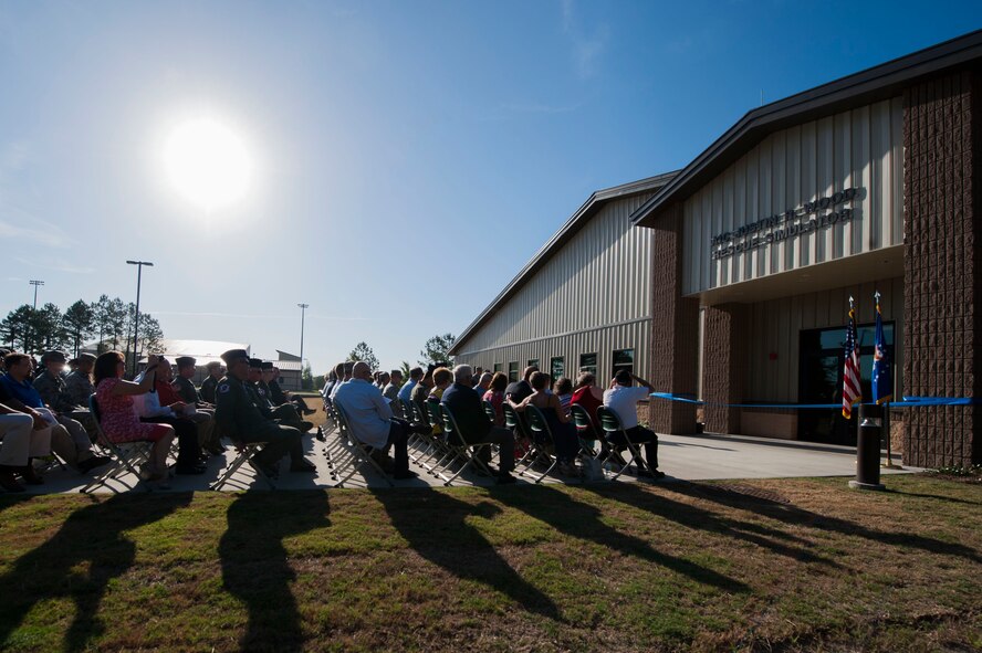 The 71st Rescue Squadron hosts a dedication ceremony for the HC-130J Rescue Simulator Building May 29, 2015, at Moody Air Force Base, Ga. The 71st RQS placed a Bronze Star commendation plaque on the building for U.S. Air Force Airman 1st Class Justin R. Wood, a former 71st RQS loadmaster and Bronze Star recipient, who was killed in action during the Khobar Towers bombing in 1996. (U.S. Air Force photo by Airman 1st Class Dillian Bamman/Released)