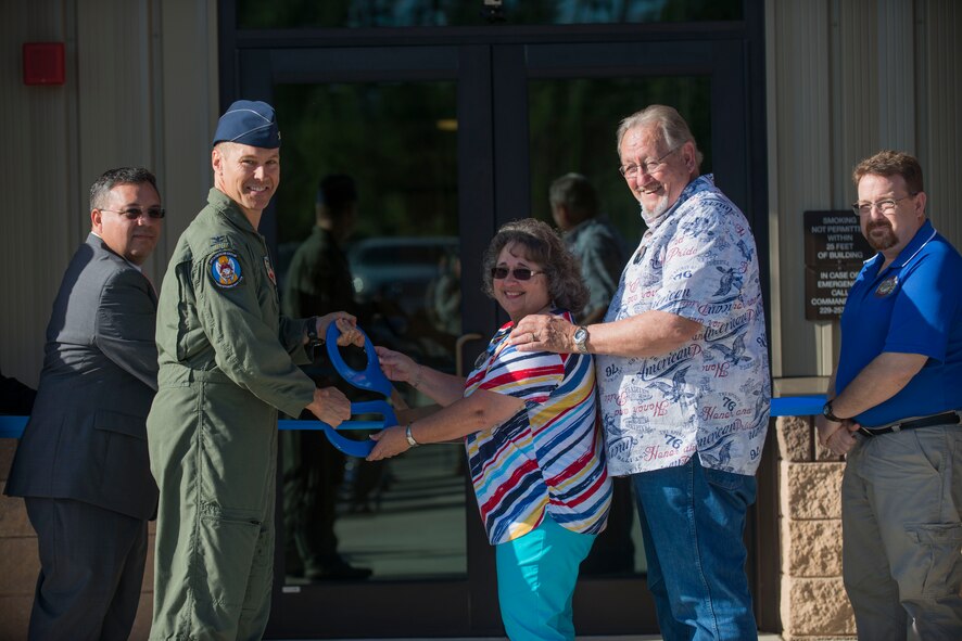 U.S. Air Force Col. Thomas Dorl, 347th Rescue Group commander, Kathleen Wood, center, and Richard Wood, second from right, parents of Airman 1st Class Justin R. Wood, and Lockheed Martin representatives pose for a photo during the HC-130J Combat King II Rescue Simulator Building dedication ceremony May 29, 2015, at Moody Air Force Base, Ga. The 71st RQS named the building in remembrance of Wood, who was killed in action during the Khobar Towers bombing in 1996. (U.S. Air Force photo by Airman 1st Class Dillian Bamman/Released)