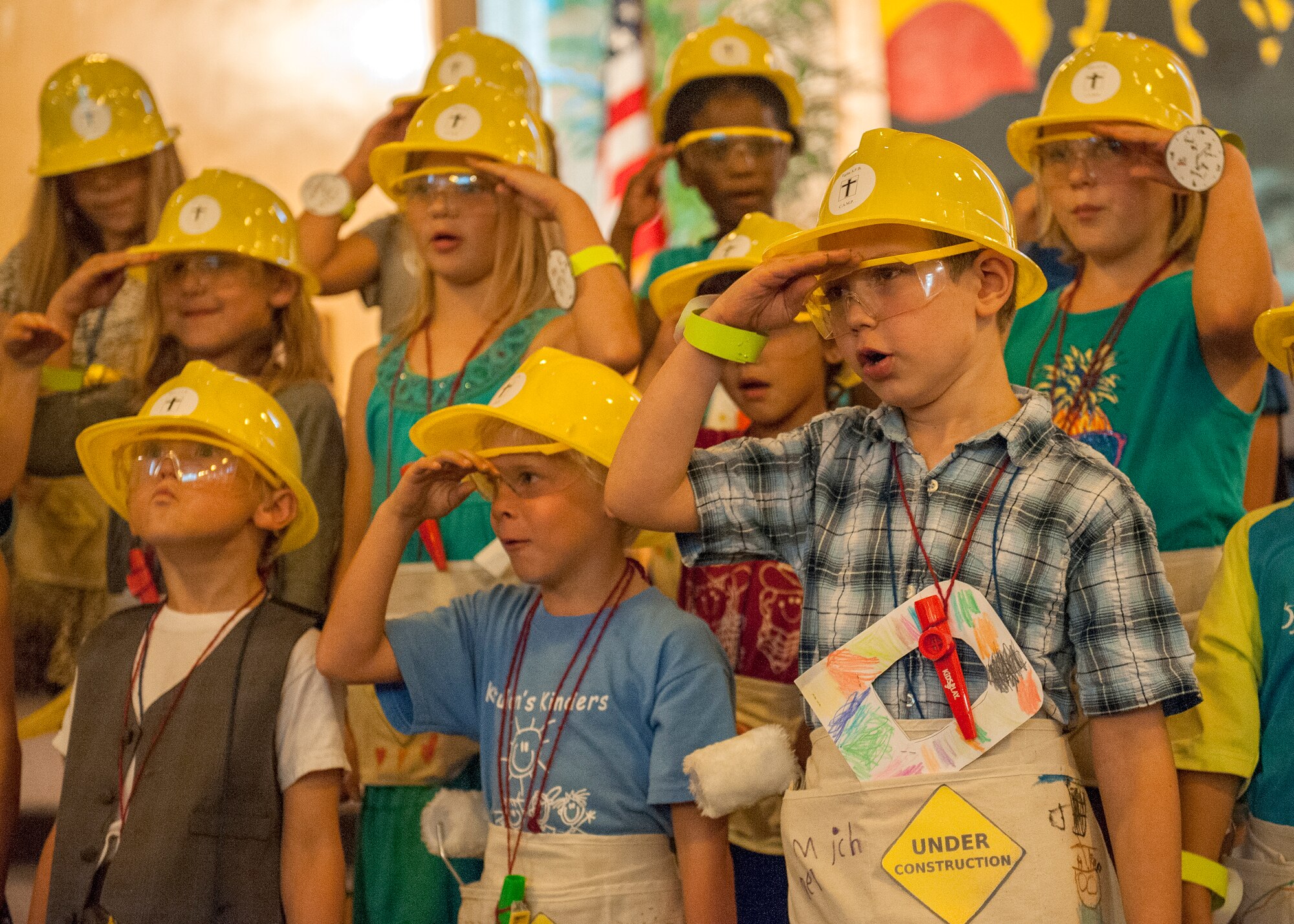 A group of children salute as they sing during the Chapel’s Arts and Music Program concert at the West Gate Chapel, May 28 at Eglin Air Force Base, Fla.  The concert concluded the after-school program that combined music, singing, story time, arts, crafts and refreshments.  Over 60 children participated in the performance as family and friends looked on.  (U.S. Air Force photo/Ilka Cole)