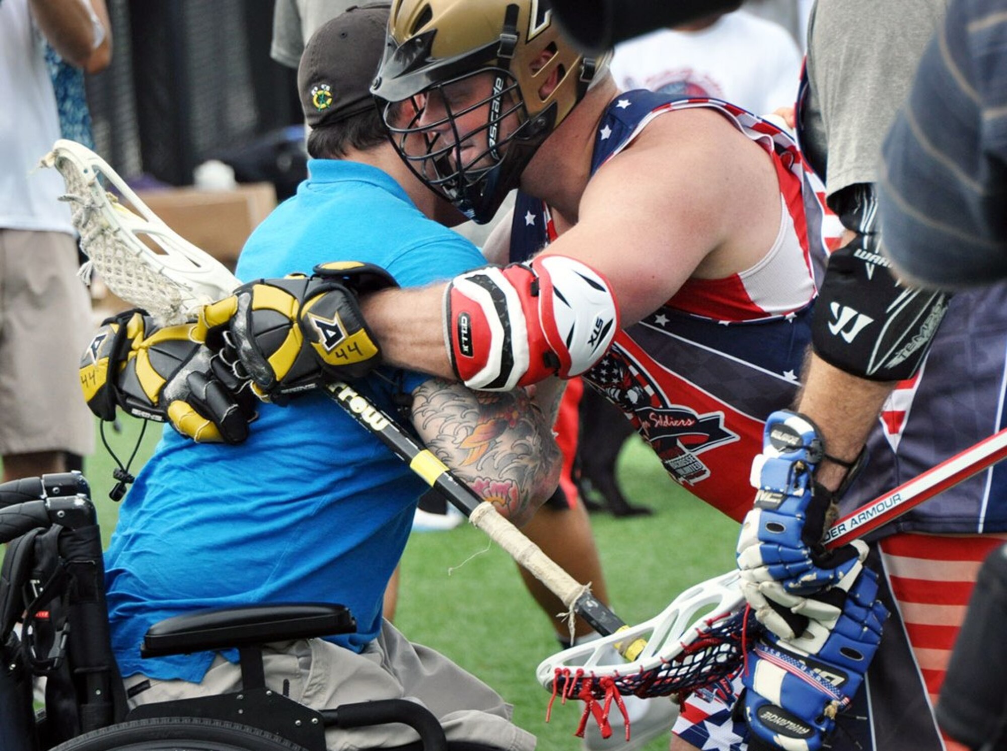 A lacrosse player and a veteran share a hug during a 2014 Shootout for Soldiers event. The program’s mission is to use the platform of lacrosse to engage communities with their local veterans and support veterans’ healthy and successful transition into civilian life. (Courtesy photo)