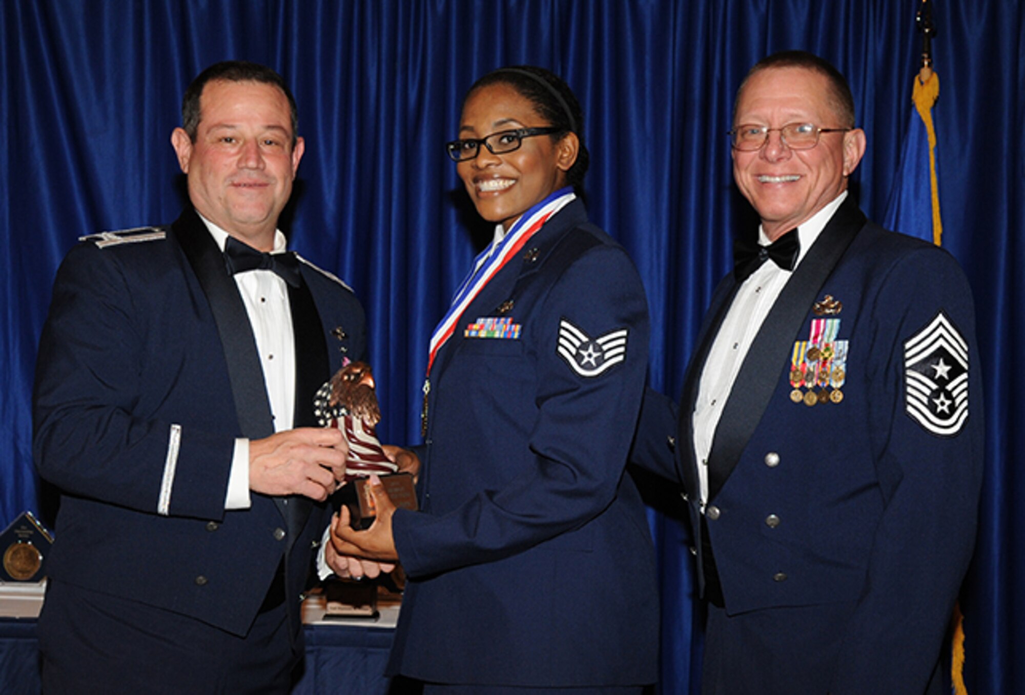 Staff Sgt. Kresston Davis, 908th Security Forces Squadron, was recognized recently as the 2014 Air Force Reserve Command Airman of the Year. Here, Davis is recognized at the 908th Airlift Wing Awards Banquet by Wing Commander Col. Adam Willis, left, and Command Chief Master Sgt. Owen Duke.

