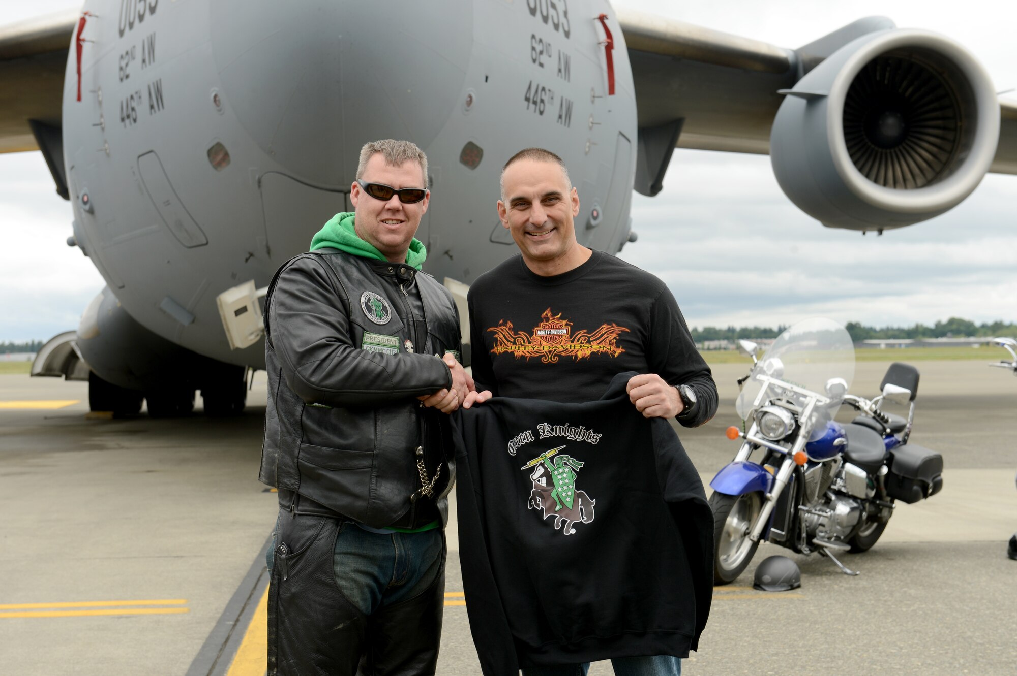 Tech. Sgt. Todd Spencer (left), Green Knights Military Motorcycle Club Chapter 3 president, presents a sweater to Col. Anthony Davit, 627th Air Base Group commander, May 23, 2015, at Joint Base Lewis-McChord, Wash. Davit was named an honorary member of the Green Knights and was also presented with the chapter colors. (U.S. Air Force photo/Airman 1st Class Keoni Chavarria)