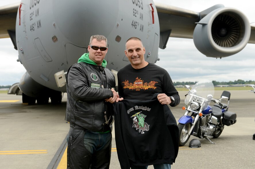 Tech. Sgt. Todd Spencer (left), Green Knights Military Motorcycle Club Chapter 3 president, presents a sweater to Col. Anthony Davit, 627th Air Base Group commander, May 23, 2015, at Joint Base Lewis-McChord, Wash. Davit was named an honorary member of the Green Knights and was also presented with the chapter colors. (U.S. Air Force photo/Airman 1st Class Keoni Chavarria)