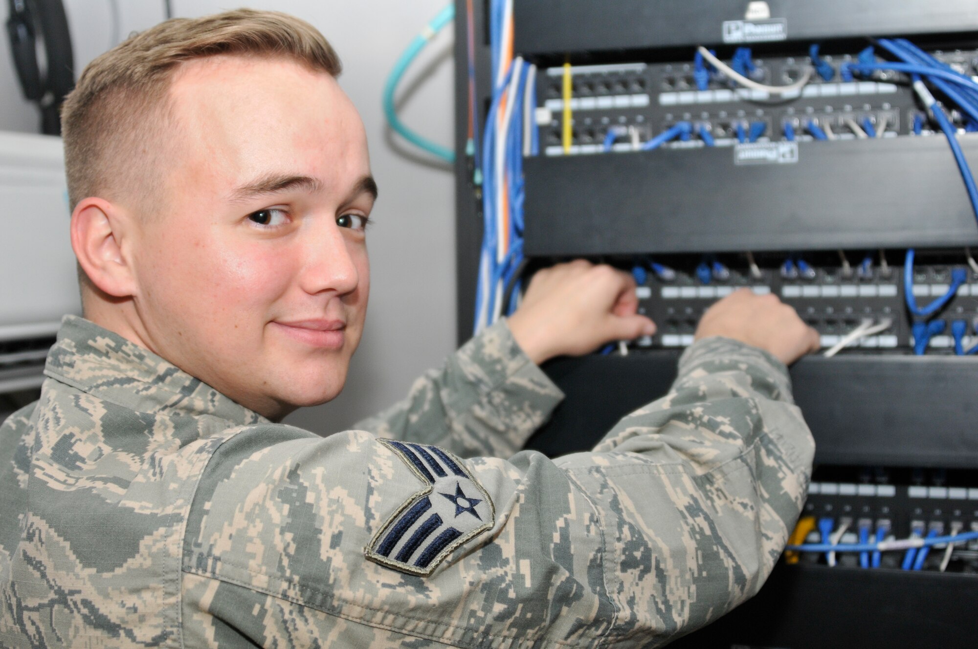 Senior Airman Corey Holt, 188th Intelligence Support Squadron client systems specialist, works on a server on Ebbing Air National Guard Base, Fort Smith, Ark. during the May unit training assembly, May 3, 2015. Holt's superiors and peers have noted him to have an exceptional work ethic and he has been selected for the June 2015 The Flying Razorback spotlight. (U.S. Air National Guard photo by Staff Sgt. John Suleski/Released)