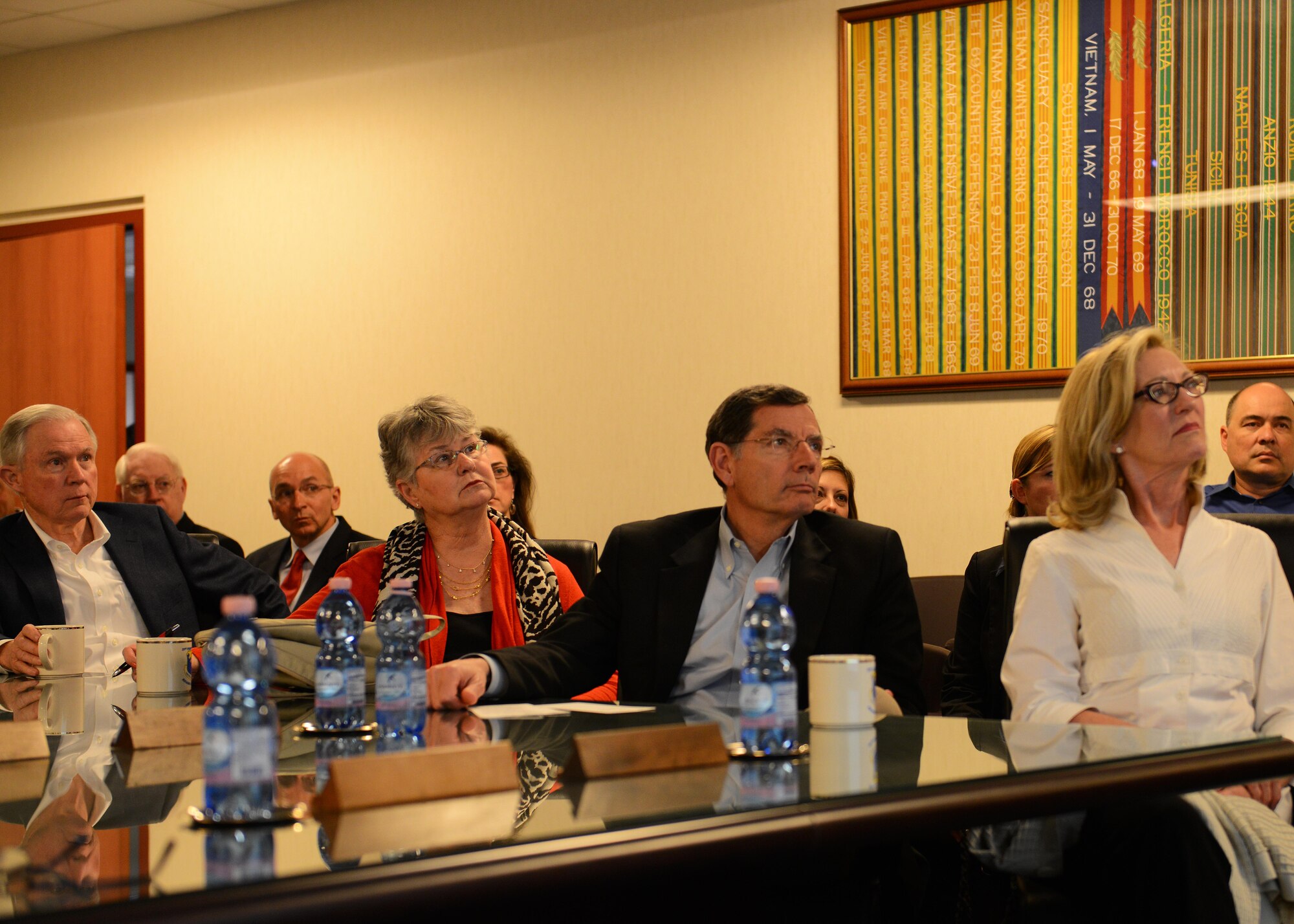 Sens. Jeff Sessions (far left) and John Barrasso (third from left) and their spouses listen to the Aviano mission brief, May 29, 2015, at Aviano Air Base, Italy. During a base tour, senators from Texas, Wyoming, Nebraska and Alabama and a representative from Texas, spoke with Airmen from their respective states during a luncheon. (U.S. Air Force photo by Airman 1st Class Deana Heitzman/Released)