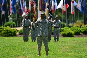 U.S. Army Maj. Terrance Montgomery, McDonald Army Health Center chief financial officer, stands at parade rest in front of the Fort Eustis Color Guard during an assumption of command ceremony at Fort Eustis, Va., May 28, 2015. Montgomery commanded the color guard and troop formations during the ceremony. (U.S. Air Force photo by Staff Sgt. Natasha Stannard/Released) 
