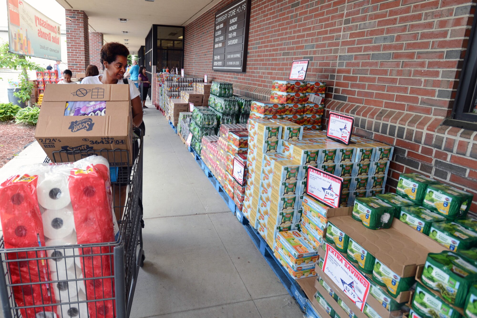 Tonja Gunn and other eligible customers shop outdoors during a case lot sale at the Hanscom Commissary May. 29. The sale was part of a customer appreciation event that was scheduled May 29 through 31. (U.S. Air Force photo by Jerry Saslav)
