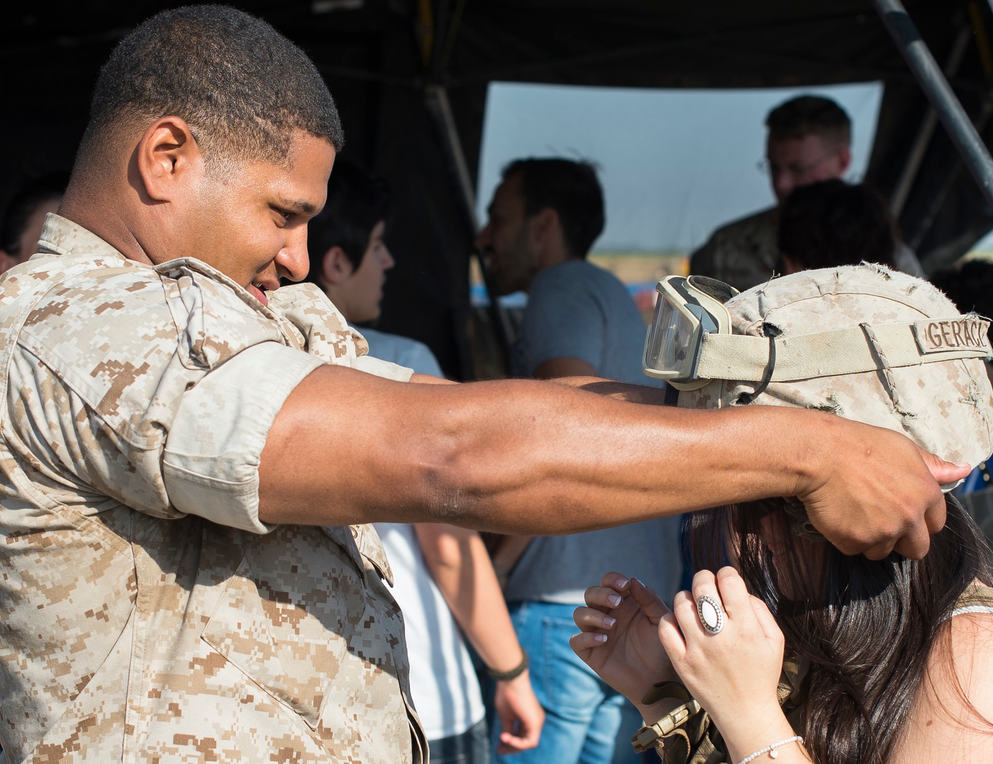 U.S. Marine Lance Cpl. Eric Reynolds, a 2d Battalion, 8th Marines infantryman, places a helmet on an open house attendee May 31, 2015, at Morón Air Base, Spain. The two-day event was held to celebrate Morón’s 75th anniversary. A variety of vehicles and weapons were on display from both the Spanish Air Force and U.S. Marines. (U.S. Air Force photo/Senior Airman Damon Kasberg)
