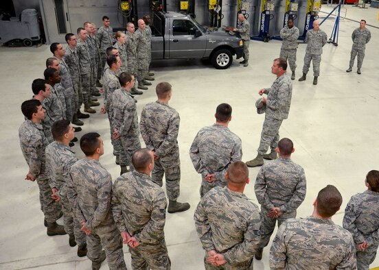 U.S. Air Force Col. Kenneth Bibb Jr., outgoing 100th Air Refueling Wing commander, speaks with Airmen from the 100th Logistics Readiness Squadron during a final tour of the base May 26, 2015, on RAF Mildenhall, England. Bibb visited with Airmen and civilians throughout the installation and thanked them for their hard work and dedication to the mission during his time stationed on RAF Mildenhall. (U.S. Air Force photo by Gina Randall/Released)