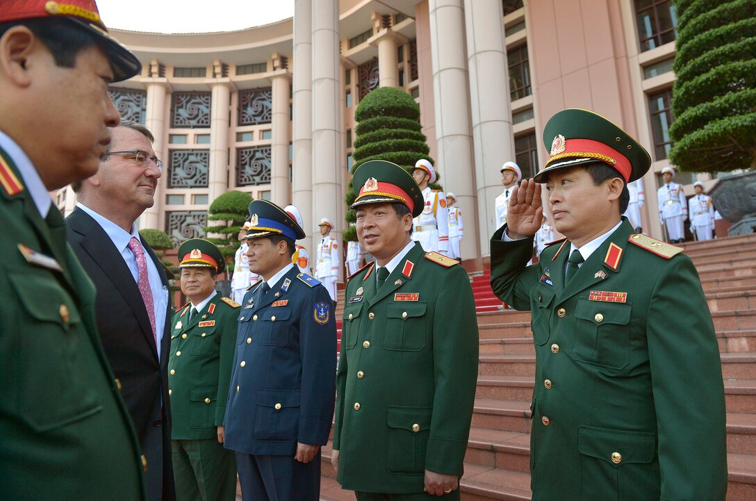 U.S. Defense Secretary Ash Carter, left, receives a salute from senior Vietnamese officers as he visits the Vietnamese Ministry of Defense and meets with Vietnamese Defense Minister Gen. Phung Quang Thanh in Hanoi, Vietnam, June 1, 2015. 
