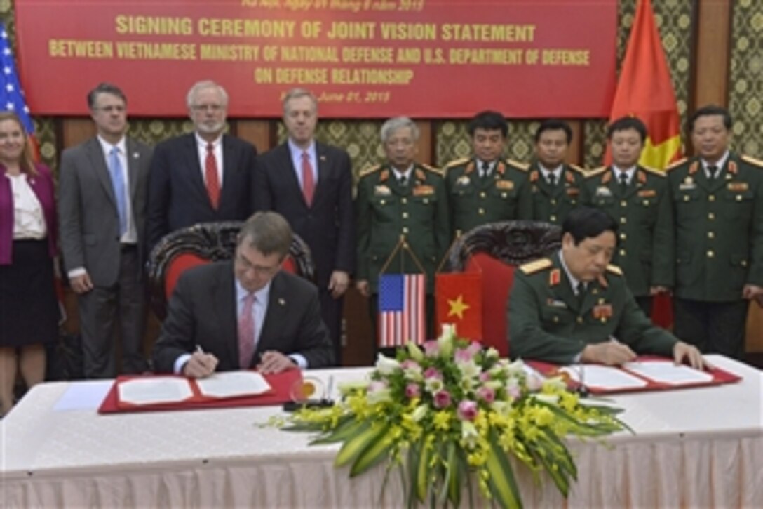 Defense Secretary Ash Carter, left, and Vietnamese Defense Minister General Phung Quang Thanh, sign a joint vision statement after meeting at the Vietnamese Ministry of Defense in Hanoi, Vietnam, June 1, 2015. Carter is on a 10-day trip to the Asia-Pacific to meet with partner nations and affirm U.S. commitment to the region. 