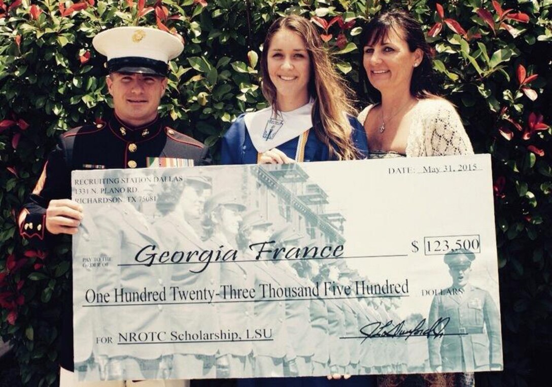 Staff Sgt. Matthew Albright presents Georgia France with a Naval Reserve
Officer Training Corps Scholarship check May 31. Selected applicants for the
NROTC Scholarship Program are awarded through a highly competitive national
selection process, and receive full tuition, books stipend, educational fees
and other financial benefits at many of the country's leading colleges and
universities. France will be attending Louisiana State University next fall.
Albright is a recruiter with Recruiting Station Dallas. (U.S. Marine Corps
photo by Sgt. Daniel E. Valle)
