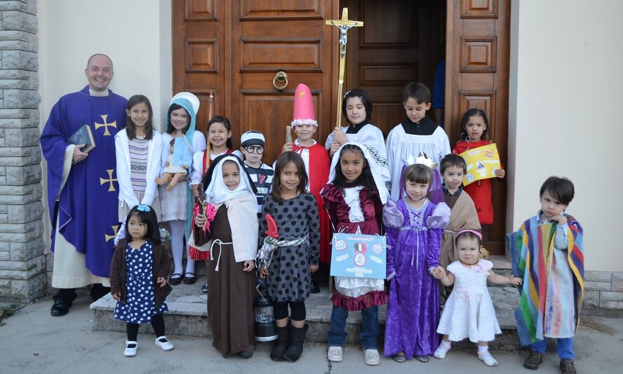 Chaplain Longe poses with a group of children during the All Saints Celebration held at Aviano Air Base, Italy.