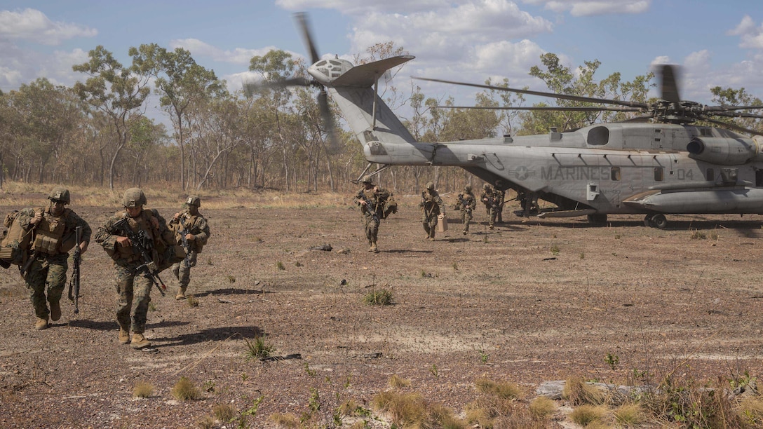 U.S. Marines with Company A, 1st Battalion, 4th Marine Regiment, Marine Rotational Force – Darwin, exit a CH-53E Super Stallion helicopter from Heavy Helicopter Squadron 463, MRF-D, during a refueling and transport operation May 22 at Mount Bundey Training Area, Northern Territory, Australia. Two CH-53Es picked up and transported approximately 140 Marines from Robertson Barracks to MBTA to begin Exercise Predator Walk. The exercise is a three-week bilateral training evolution with the Australian Army and enables Marines to become familiar with and improve their knowledge of the Australians’ technical and tactical procedures and standard operating procedures to strengthen interoperability. (U.S. Marine Corps photo by Cpl. Reba James/Released)
