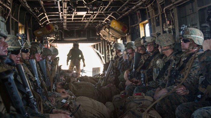 A platoon of U.S. Marines with Company A, 1st Battalion, 4th Marine Regiment, MRF-D, sit with their gear inside of a CH-53E Super Stallion helicopter during a refueling and transport operation May 22 at Mount Bundey Training Area, Northern Territory, Australia. Two CH-53Es picked up and transported approximately 140 Marines from Robertson Barracks to MBTA to begin Exercise Predator Walk. The exercise is a three-week bilateral training evolution with the Australian Army and enables Marines to become familiar with and improve their knowledge of the Australians’ technical and tactical procedures and standard operating procedures to strengthen interoperability. (U.S. Marine Corps photo by Cpl. Reba James/Released)