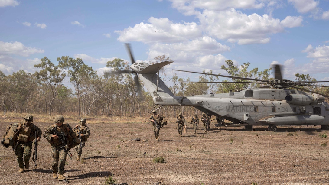 U.S. Marines with Company A, 1st Battalion, 4th Marine Regiment, Marine Rotational Force – Darwin, exit a CH-53E Super Stallion helicopter from Heavy Helicopter Squadron 463, MRF-D, during a refueling and transport operation May 22 at Mount Bundey Training Area, Northern Territory, Australia. Two CH-53Es picked up and transported approximately 140 Marines from Robertson Barracks to MBTA to begin Exercise Predator Walk. The exercise is a three-week bilateral training evolution with the Australian Army and enables Marines to become familiar with and improve their knowledge of the Australians’ technical and tactical procedures and standard operating procedures to strengthen interoperability.