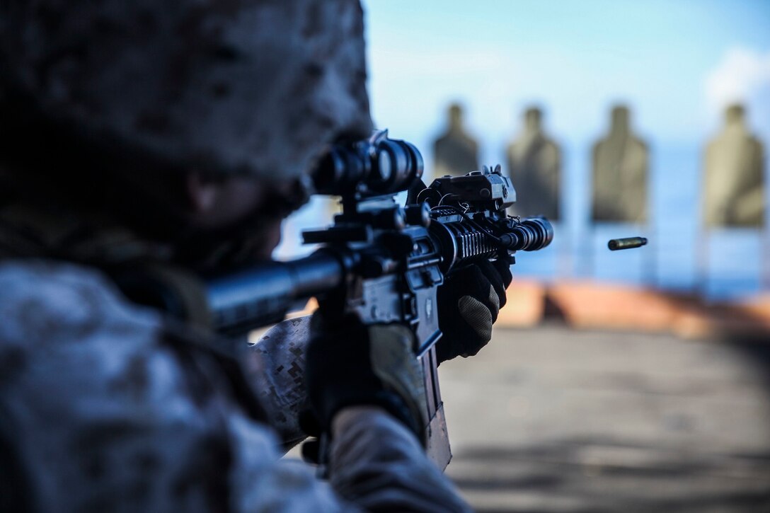 U.S. Marine Sgt. Justin Leduc shoots at his target aboard the USS Essex (LHD 2) at sea in the Pacific Ocean, June 1, 2015. Leduc is a military policeman with Law Enforcement Detachment, Combat Logistics Battalion 15, 15th Marine Expeditionary Unit. He is also an enabler with the 15th Marine Expeditionary Unit’s Maritime Raid Force. The law enforcement Marines assist the MRF with tactical site exploitation during their missions. (U.S. Marine Corps photo by Cpl. Anna Albrecht/Released)