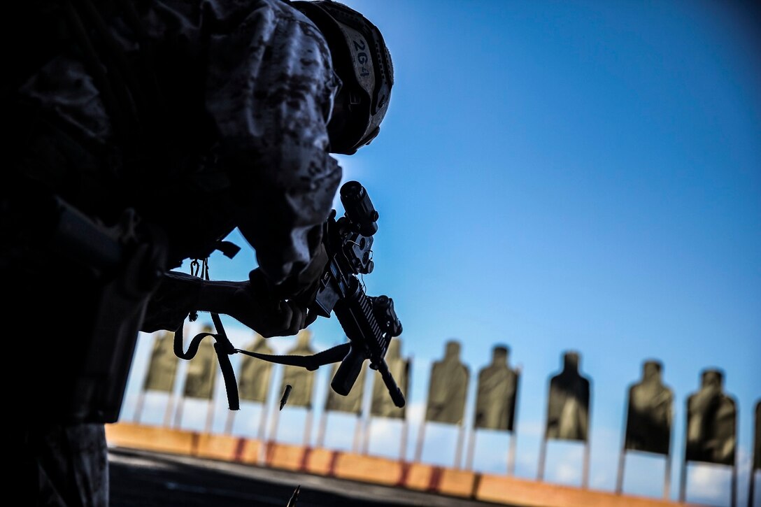A U.S. Marine with the 15th Marine Expeditionary Unit’s Maritime Raid Force takes a knee to clear out a double-feed aboard the USS Essex (LHD 2) at sea in the Pacific Ocean, June 1, 2015. These Marines practice malfunction drills frequently so they know how to quickly and efficiently clear it out if it ever occurs during a mission. (U.S. Marine Corps photo by Cpl. Anna Albrecht/Released)