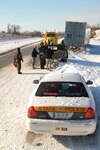 Illinois National Guard members work with Illinois State Troopers to move a stranded semi-truck, Feb. 2, 2011, on Interstate 72, near Pittsfield. The Illinois National Guard worked with Troopers to assist stranded motorists after Gov. Pat Quinn called approximately 500 Guard members to state active duty for a winter weather emergency.