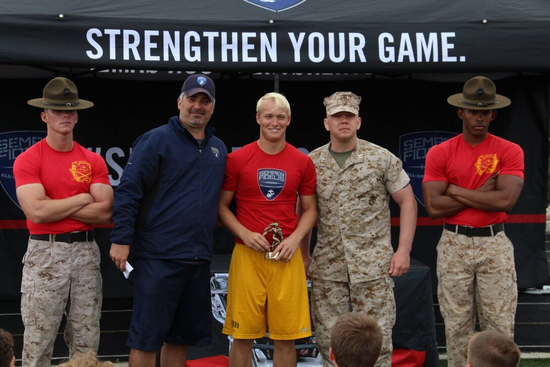 Marines from Recruiting Station Indianapolis and Marine Corps Recruit Depot San Diego from healped lead in the RS Indianapolis Semper Fidelis All-American Football Camp at Decatur Central High School's May 31, 2015.
Alex Fabert was awarded a leadership award during the camp by (left-to-right) SSgt Berryhill, Coach Caz Kosciolek, Captain Matthew A. Lamb and SSgt Jones.
