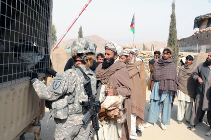 An Afghan man waits in line for chickens at Combat Outpost Terezayi, Khowst province, Feb. 2, 2011. The chickens were distributed to local farmers who attended a poultry management class sponsored by the Afghan Director of Agriculture, Irrigation and Livestock. Soldiers from the Indiana National Guard's 3-19th Agribusiness Development Team, attached to the 3rd Brigade Combat Team, 1st Infantry Division, helped facilitate the training. 