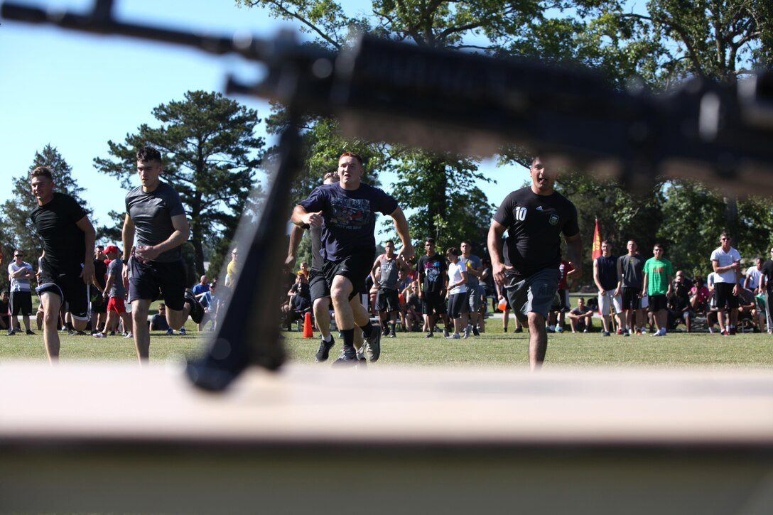 Marines participate in a rifle relay race during a field meet at Marine Corps Air Station Cherry Point, N.C., May 29, 2015. Marines with Marine Wing Support Squadron 271 went head-to-head with each other in a tug-of-war, a 7-ton pull, relay races and other events to build teamwork, camaraderie and spirit-de-corps.