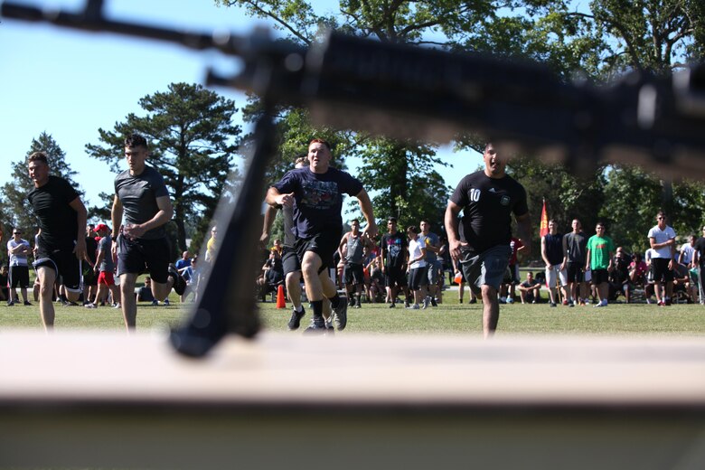 Marines participate in a rifle relay race during a field meet at Marine Corps Air Station Cherry Point, N.C., May 29, 2015. Marines with Marine Wing Support Squadron 271 went head-to-head with each other in a tug-of-war, a 7-ton pull, relay races and other events to build teamwork, camaraderie and spirit-de-corps.