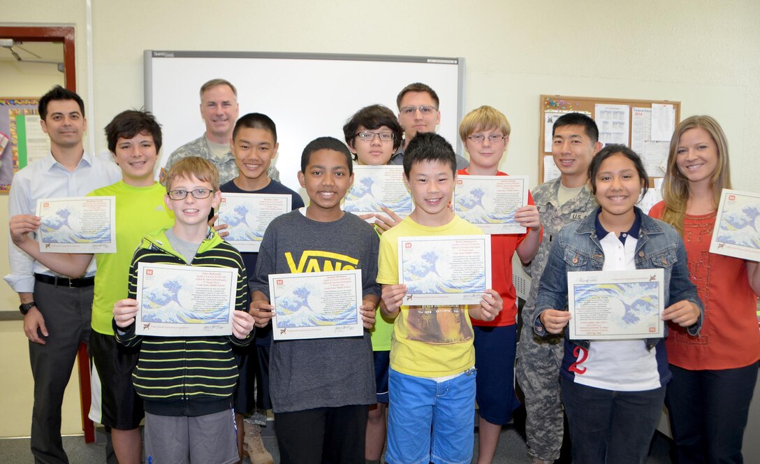 Col. John Hurley, commander of the USACE, Japan District and three engineers from the district visited Zama American Middle School May 27 as part of the Science, Technology Engineering and Math Education Program (STEM Ed) to help judge projects for a 7th grade science class. The projects culminated a six week session on “Natural Hazards and Disasters” conducted by Japan District volunteers Andrew Chan, John Feller, Andrew Jordan, and 1st Lt. Brian Liu in collaboration with Zama American Middle School teacher Georgina Ruisi. Throughout the six week period, Chan, Feller, Jordan, and 1st Lt. Brian Liu helped to facilitate the classroom sessions, providing real world engineering insight and face to face interaction with the teacher and students. At the session end, Col. Hurley provided Ruisi and the students with certificates for participating in the program. ‪#USACE‬ Photos by Rashida Banks.