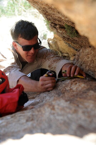 U.S. Marines Corps Cpl. James LaFrance, reconnaissance Marine, practices anchoring a rope using improvised rappel anchors during Angel Thunder 2015 high angle rescue training at Mount Lemmon, Ariz., June 1, 2015. During the training, U.S. Marines and U.S. Airmen practiced tying knots, anchoring ropes, rappelling down a cliffside unassisted, and returning to the initial elevation point.  Angel Thunder is an Air Combat Command-sponsored personnel recovery exercise for combat air force, joint, allied and interagency participants. LaFrance is assigned to Force Company, 1st Reconnaissance Battalion, 1st Marine Division at Camp Pendleton, Calif. (U.S. Air Force photo by Senior Airman Betty R. Chevalier/Released)