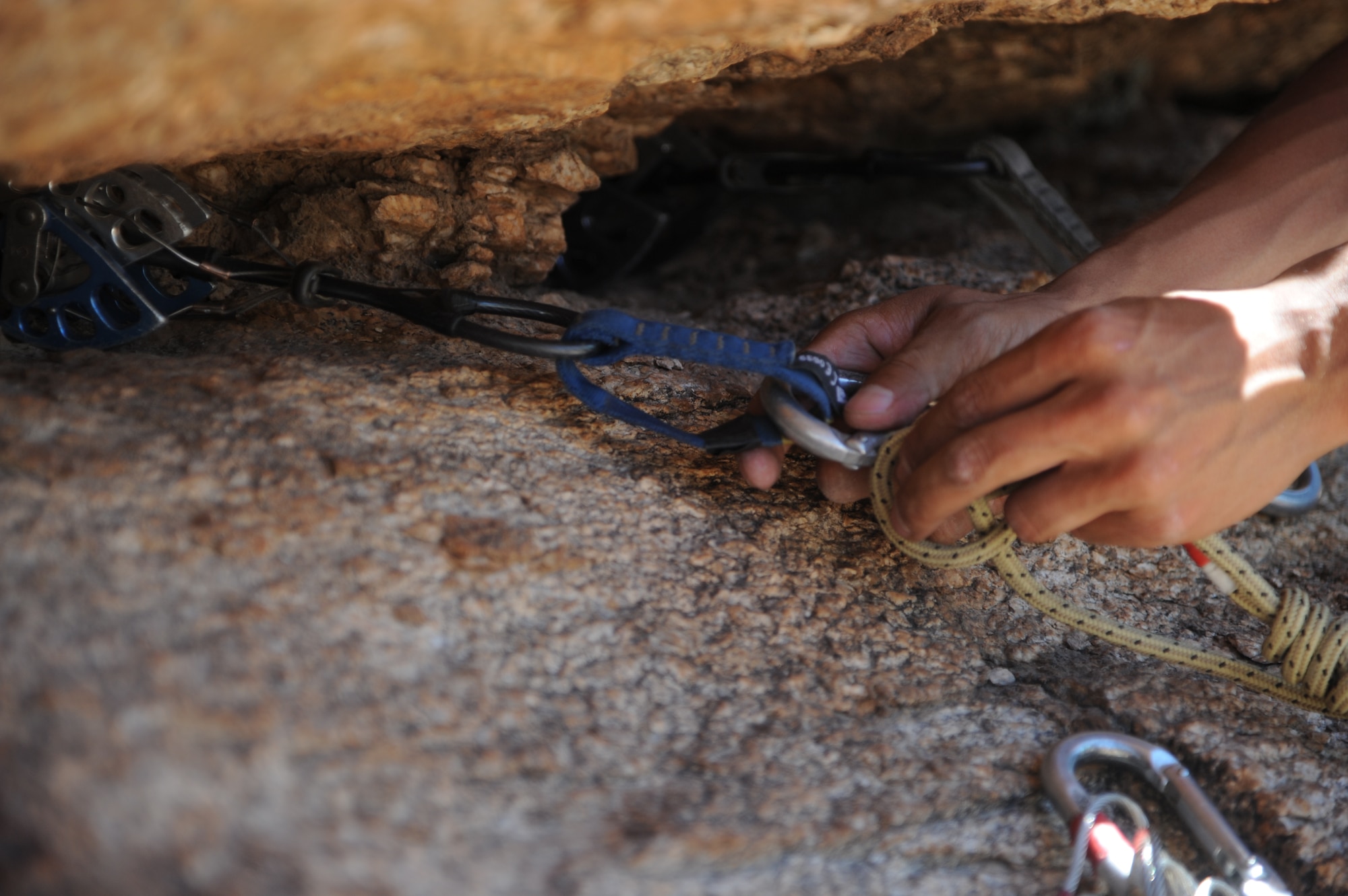 U.S. Marine Corps Sgt. Adam Martinez, Expeditionary Operations Training Group Angel Thunder 2015 high angle rescue training at Mount Lemmon, Ariz., June 1, 2015. During the training, U.S. Marines and U.S. Airmen practiced tying knots, anchoring ropes, rappelling down a cliffside unassisted, and returning to the initial elevation point. Angel Thunder is an Air Combat Command-sponsored personnel recovery exercise for combat air force, joint, allied and interagency participants. The Marines are assigned to Force Company, 1st Reconnaissance Battalion, 1st Marine Division at Camp Pendleton, Calif. (U.S. Air Force photo by Senior Airman Betty R. Chevalier/Released)