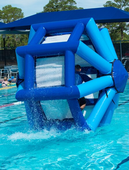 U.S. Air Force Col. Chad Franks, 23d Wing commander, sprints across the outdoor pool in a water wheel June 1, 2015, at Moody Air Force Base, Ga. Franks finished the challenge with a time of 49 seconds. (U.S. Air Force photo by Airman 1st Class Kathleen D. Bryant)  