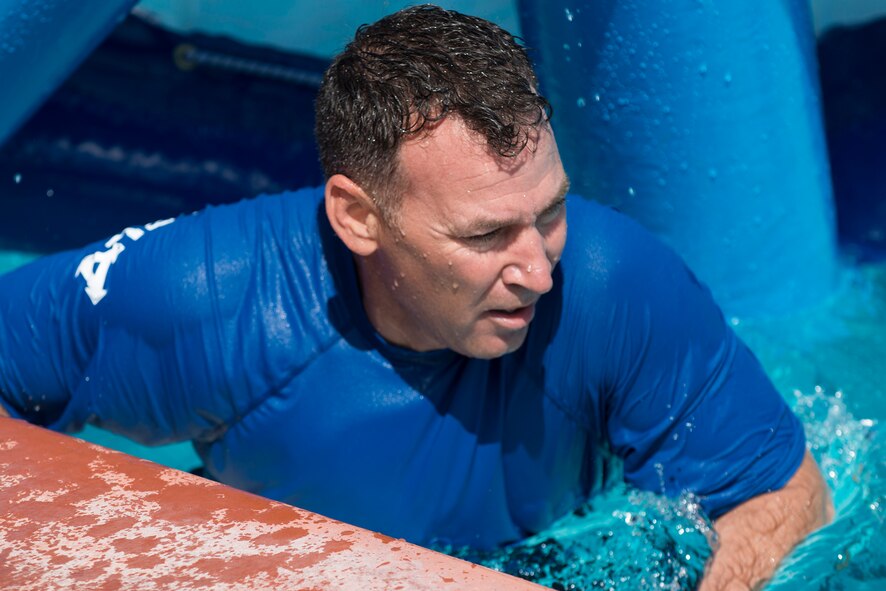 U.S. Air Force Col. Chad Franks, 23d Wing commander, exits the pool after a water wheel challenge June 1, 2015, at Moody Air Force Base, Ga. Franks’ time of 49 seconds will be challenged during the Build a Boat on June 18. (U.S. Air Force photo by Airman 1st Class Kathleen D. Bryant)