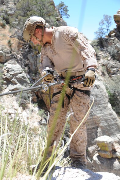 U.S. Marine Corporal Dan Peete, reconnaissance Marine, prepares to rappel down a cliffside during Angel Thunder 2015 high angle rescue training at Mount Lemmon, Ariz., June 1, 2015. Exercise Angel Thunder is the world’s largest personnel recovery exercise, hosting 11 partner nations and nine inter-agencies at Davis-Monthan Air Force Base in Tucson, Ariz.  Peete is assigned to Force Company, 1st Reconnaissance Battalion, 1st Marine Division at Camp Pendleton, Calif. (U.S. Air Force photo by Tech. Sgt. Courtney Richardson)