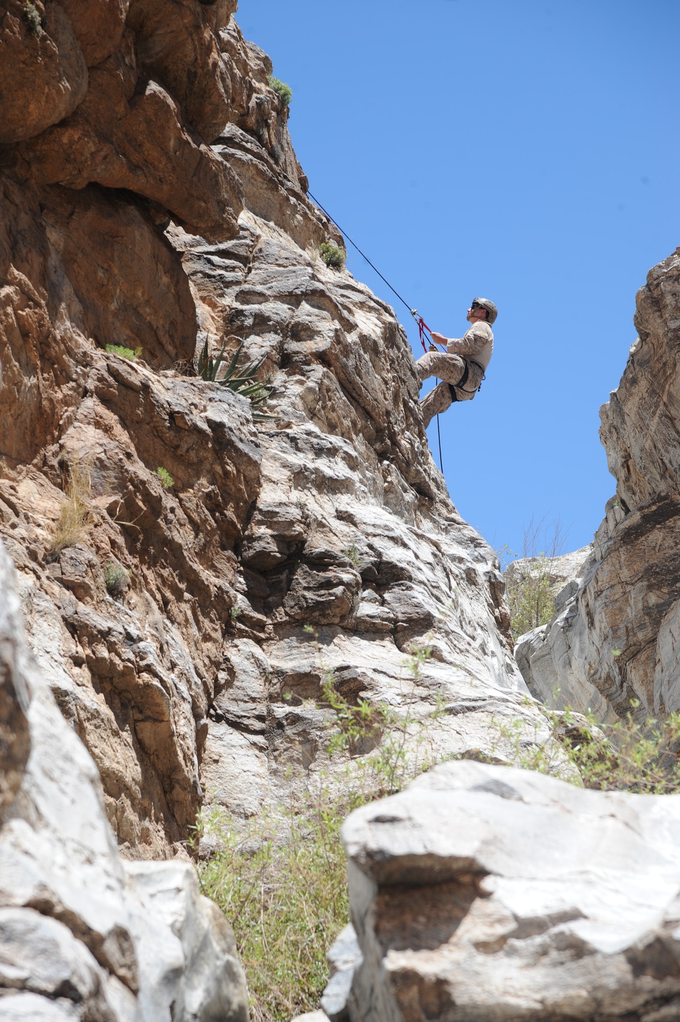 U.S. Marine Cpl. James LaFrance, reconnaissance Marine, rappels down a cliffside during  Angel Thunder 2015 high angle rescue training at Mount Lemmon, Ariz., June 1, 2015. During the training, U.S. Marines and U.S. Airmen practiced tying knots, anchoring ropes properly, rappelling down a cliffside unassisted, and returning to the initial elevation point. LaFrance is a assigned to Force Company, 1st Reconnaissance Battalion, 1st Marine Division at Camp Pendleton, Calif. (U.S. Air Force photo by Tech. Sgt. Courtney Richardson/Released)