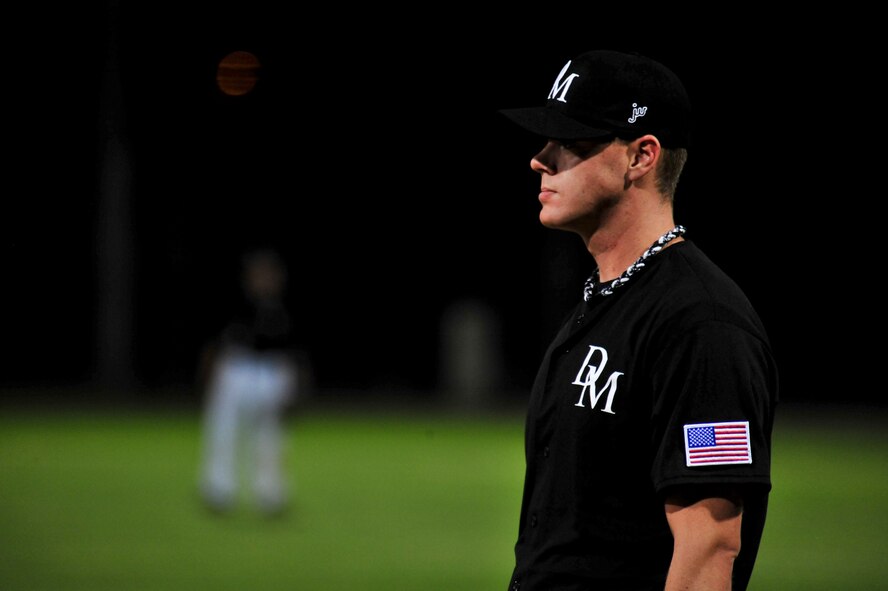 U.S. Air Force Senior Airman Russell LewisPablo, 25th Operational Weather Squadron weather forecaster and resource protection specialist, waits for the third inning to begin while playing first base during a baseball game at Reid Park, Tucson, Ariz., April 10, 2015. LewisPablo will travel to Washington and Oregon to play for the U.S. Military All-Stars baseball team throughout June. (U.S. Air Force photo by Airman 1st Class Chris Massey/Released)