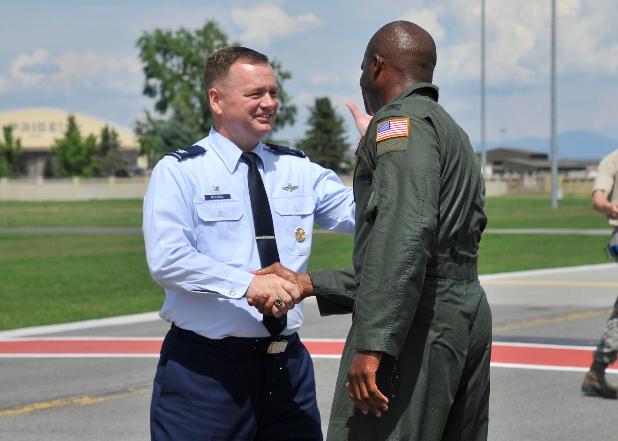 Col. Brian Hill, 92nd Air Refueling Wing vice commander, shakes the hand of Col. Brian McDaniel, 92nd ARW commander, May 29, 2015, at Fairchild Air Force Base, Wash. Hill spent the last two years as the vice commander of the 92nd ARW, and will now spend the next few years at the Air Force Academy before he retires. (U.S. Air Force photo/Airman 1st Class Taylor Bourgeous)